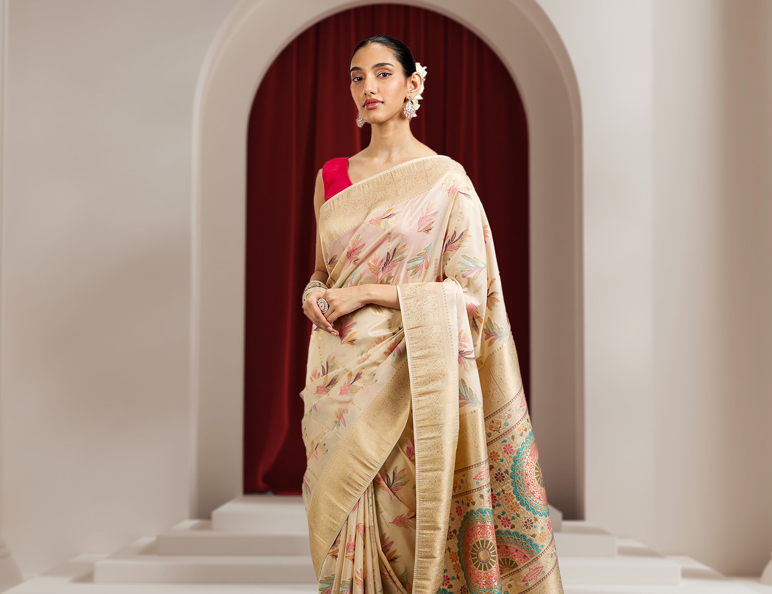 Woman wearing a white printed saree styled for a wedding or festive photoshoot